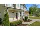 Close-up of a home's inviting front porch with landscaping and a stone-accented garage at 130 Hilldebrant Dr, Franklinton, NC 27525