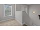 Upstairs hallway with two windows and carpeted stairs at 130 Hilldebrant Dr, Franklinton, NC 27525