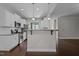 Kitchen with white cabinets, stainless steel appliances, hardwood floors and breakfast bar with stone countertop at 130 Hilldebrant Dr, Franklinton, NC 27525