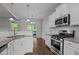Bright kitchen boasts stainless steel appliances, white subway tile backsplash, and wood flooring at 130 Hilldebrant Dr, Franklinton, NC 27525