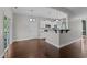 Eat-in kitchen featuring stainless steel appliances, white cabinets, an eating bar, and hardwood flooring at 130 Hilldebrant Dr, Franklinton, NC 27525