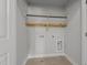 Functional laundry room with shelving and washer-dryer hookups, plus tiled floors at 130 Hilldebrant Dr, Franklinton, NC 27525