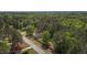 A beautiful aerial view showcasing a house with lush trees, landscaping, and a peaceful neighborhood setting at 14 Shire Ct, Zebulon, NC 27597