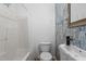 Bathroom featuring a stylish vanity and marbled wallpaper at 14 Shire Ct, Zebulon, NC 27597