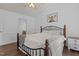 Charming bedroom featuring an iron bed frame, hardwood floors, and light walls at 14 Shire Ct, Zebulon, NC 27597
