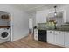 Stylish kitchen with white cabinets, laminate floors, granite countertops, and stainless-steel appliances at 14 Shire Ct, Zebulon, NC 27597