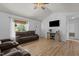 Bright living room featuring hardwood floors, a ceiling fan, a TV, and lots of natural light at 14 Shire Ct, Zebulon, NC 27597