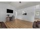 Open-concept living room with hardwood floors and modern decor, adjacent to the kitchen area at 14 Shire Ct, Zebulon, NC 27597