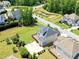 Aerial view showcases a spacious backyard, wooden deck, a basketball court and lush landscaping at 1429 Wragby Ln, Apex, NC 27502