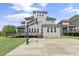 View of the backyard featuring a basketball court, back deck and screened in porch at 1429 Wragby Ln, Apex, NC 27502