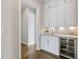 Stylish bar featuring white cabinets, tile backsplash, and wine fridge at 1429 Wragby Ln, Apex, NC 27502