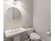 A modern bathroom with a pedestal sink and toilet with bidet at 1429 Wragby Ln, Apex, NC 27502