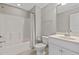 Bathroom with a tub-shower combo, white fixtures, and a neutral color palette at 1429 Wragby Ln, Apex, NC 27502