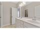 Bathroom with double sinks, white cabinetry, and a large mirror, offering ample space at 1429 Wragby Ln, Apex, NC 27502