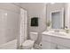 Well-lit bathroom featuring a shower-tub combo with a modern, polka-dot shower curtain at 1429 Wragby Ln, Apex, NC 27502