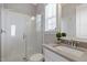 Bright bathroom with a glass enclosed shower and a gray countertop vanity with a white undermount sink at 1429 Wragby Ln, Apex, NC 27502