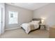 Cozy bedroom featuring a bed with white linens, a side table, and a window with natural light at 1429 Wragby Ln, Apex, NC 27502