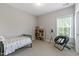 Cozy bedroom with carpeted floors and a large window for natural light, offering a comfortable retreat at 1429 Wragby Ln, Apex, NC 27502