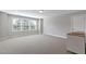 Large bonus room with neutral carpet, plenty of windows, and versatile space at 1429 Wragby Ln, Apex, NC 27502