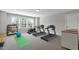 Spacious home gym featuring modern equipment, including treadmills, an exercise bike, and weights at 1429 Wragby Ln, Apex, NC 27502