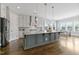 This kitchen features pendant lights over an island, stainless appliances, and a breakfast nook at 1429 Wragby Ln, Apex, NC 27502