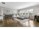Open-concept living room and kitchen area with hardwood floors and natural light at 1429 Wragby Ln, Apex, NC 27502