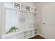 Organized mudroom with custom shelving, hooks, and bench seating for convenient storage at 1429 Wragby Ln, Apex, NC 27502