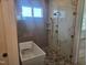 Beautiful bathroom with large marble shower, soaking tub, and custom tile design at 15 Independence Dr, Smithfield, NC 27577