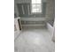 Bathroom features tile floor, tub, and window allowing natural light to fill the space at 15 Independence Dr, Smithfield, NC 27577