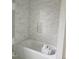 Tiled bathroom tub and surround with cubby is ready for the finishing touches at 15 Independence Dr, Smithfield, NC 27577