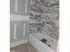 Stylish bathroom with marble tile, a built-in shower niche, and a new soaking tub at 15 Independence Dr, Smithfield, NC 27577