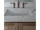 A lovely white undermount sink with stylish bronze hardware complements a white and woodgrain vanity at 15 Independence Dr, Smithfield, NC 27577