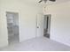 A sunlit bedroom features neutral carpet, a ceiling fan, and walk-in closet at 15 Independence Dr, Smithfield, NC 27577