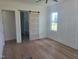 Bright bedroom with hardwood floors, white trim, and barn door to bathroom at 15 Independence Dr, Smithfield, NC 27577
