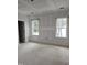 A bright and airy bedroom with two large windows and a closet at 15 Independence Dr, Smithfield, NC 27577