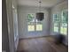 Bright dining area featuring hardwood floors, large windows, and a contemporary light fixture at 15 Independence Dr, Smithfield, NC 27577