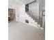 Elegant foyer with stairs featuring modern railing and adjacent kitchen with cabinetry at 15 Independence Dr, Smithfield, NC 27577
