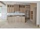 Unfinished kitchen boasting custom wooden cabinets and a center island with vertical wood slat detailing at 15 Independence Dr, Smithfield, NC 27577