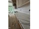 Close-up of kitchen counter featuring beautiful marble countertops and custom wood cabinets at 15 Independence Dr, Smithfield, NC 27577