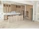 Unfinished kitchen boasting custom wooden cabinets and a center island with vertical wood slat detailing at 15 Independence Dr, Smithfield, NC 27577