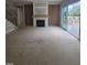 Open living room featuring a fireplace with wood mantle and sliding glass doors to the outdoor deck at 15 Independence Dr, Smithfield, NC 27577