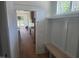 Mud room area with bench seating, storage, and view into the kitchen featuring wood cabinets and modern appliances at 15 Independence Dr, Smithfield, NC 27577
