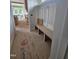 Mud room featuring a custom-built wooden bench seat with a view of the home's unfinished kitchen at 15 Independence Dr, Smithfield, NC 27577