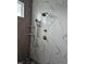 Detailed shower featuring rainfall showerhead, handheld wand, and marble tile walls at 15 Independence Dr, Smithfield, NC 27577