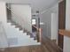 Modern staircase design with wood and metal railing, and decorative wood accent wall at 15 Independence Dr, Smithfield, NC 27577
