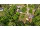 Aerial view of the property highlighting mature trees, landscaping, and neighborhood at 160 Fox Run Rd, Youngsville, NC 27596