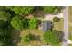 An aerial view of a quaint home with a large driveway and surrounded by lush trees at 160 Fox Run Rd, Youngsville, NC 27596