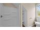 Bathroom featuring an accessible shower and toilet, with ample storage shelves at 160 Fox Run Rd, Youngsville, NC 27596