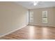Spacious bedroom featuring hardwood floors, neutral paint and natural light from two windows at 160 Fox Run Rd, Youngsville, NC 27596
