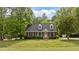Classic brick home featuring black shutters, dormer windows, and a lush green lawn at 160 Fox Run Rd, Youngsville, NC 27596